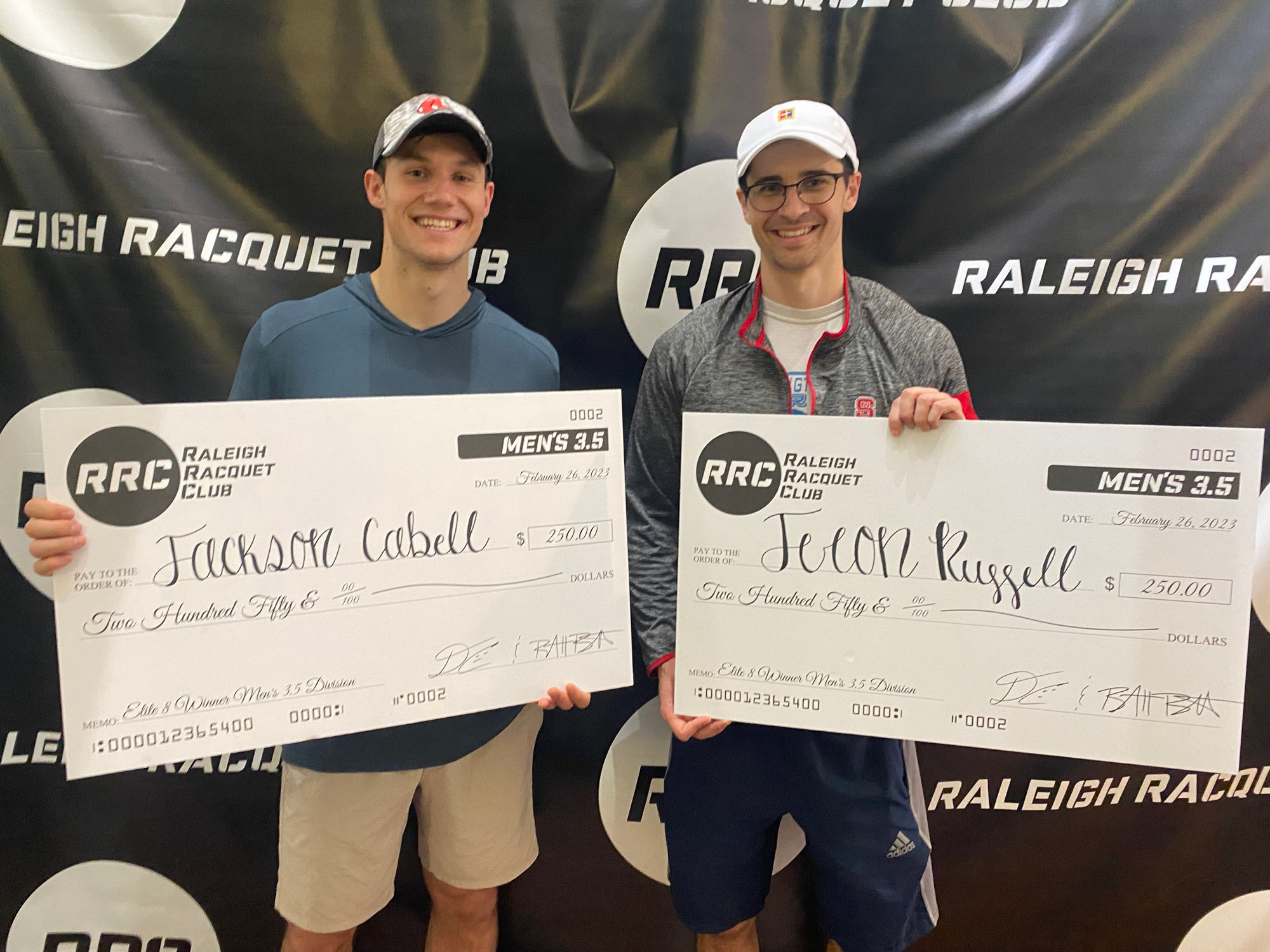 Jackson and Jeron holding winner's checks at Raleigh Racquet Club